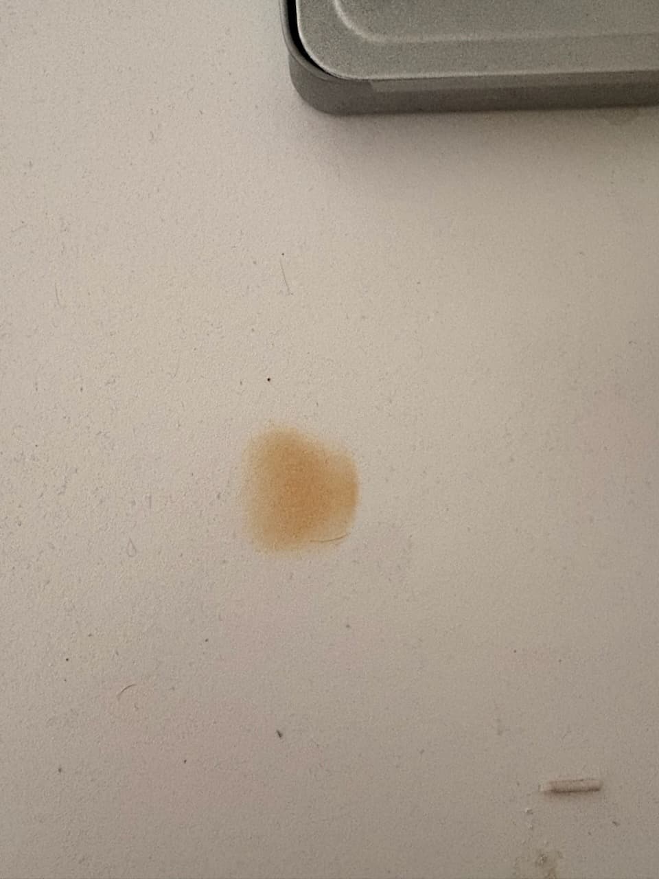 Example close-up: a burn mark on a stone benchtop, filling the frame.