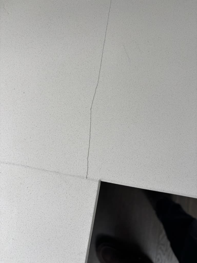 Before: a crack across a white engineered stone benchtop.