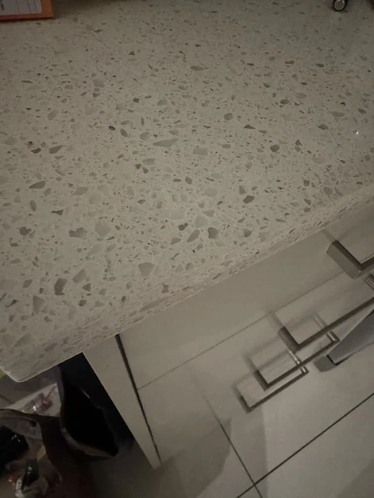 A stone benchtop with the chip repaired, from a customer review.